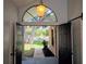 View of the front yard with mature trees through the open double doors of the home at 2181 Wekiwa Oaks Dr, Apopka, FL 32703