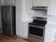 The kitchen has stainless steel appliances, granite countertops, white cabinets and laminate flooring at 2181 Wekiwa Oaks Dr, Apopka, FL 32703