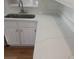Close up of the kitchen countertops that have a new white color with subtle gold accents at 2181 Wekiwa Oaks Dr, Apopka, FL 32703