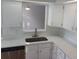 This kitchen features white cabinets, stainless steel appliances, and stunning white countertops at 2181 Wekiwa Oaks Dr, Apopka, FL 32703