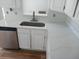 Modern kitchen sink with sleek quartz countertops, white cabinets, and stainless steel appliances at 2181 Wekiwa Oaks Dr, Apopka, FL 32703