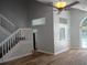 Spacious living room with vaulted ceiling, wood floors, and stairs to the second floor at 2181 Wekiwa Oaks Dr, Apopka, FL 32703