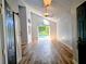 Bright living room with vaulted ceiling, wood floors, and an open doorway to the pool area at 2181 Wekiwa Oaks Dr, Apopka, FL 32703