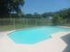 An in-ground pool with a fence and green landscaping at 2181 Wekiwa Oaks Dr, Apopka, FL 32703