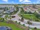 Beautiful aerial view of a residential community with a lake, lush landscaping, and blue skies at 2311 Chatham Place Dr, Orlando, FL 32824