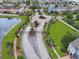 Gated community entrance with a roundabout, mature landscaping, and water feature at 2311 Chatham Place Dr, Orlando, FL 32824