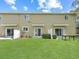 Back of the home features a well-maintained grassy backyard, perfect for outdoor entertaining at 2311 Chatham Place Dr, Orlando, FL 32824