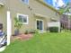 Backyard has a large well maintained lawn area and a landscaped bed adjacent to the building at 2311 Chatham Place Dr, Orlando, FL 32824
