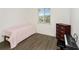 Bedroom with a window, a piano and bench, a dresser and laminate wood flooring at 2311 Chatham Place Dr, Orlando, FL 32824