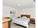 Bedroom features a wooden bed frame, laminate wood flooring and bedside tables at 2311 Chatham Place Dr, Orlando, FL 32824