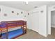 bedroom features a wooden bunk bed, closet and artistic flower decals on the wall at 2311 Chatham Place Dr, Orlando, FL 32824