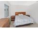 Bedroom features a wooden bed frame, laminate wood flooring and bedside tables at 2311 Chatham Place Dr, Orlando, FL 32824