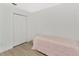 Bedroom with a bed and a double door closet, also features laminate wood flooring at 2311 Chatham Place Dr, Orlando, FL 32824