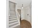 Entryway with a staircase leading to the second floor, tiled floors, and two doors at 2311 Chatham Place Dr, Orlando, FL 32824