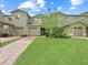 Beautiful two-story home with a well-manicured lawn and brick driveway at 2311 Chatham Place Dr, Orlando, FL 32824