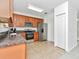 Spacious kitchen with stainless steel appliances and wood cabinets at 2311 Chatham Place Dr, Orlando, FL 32824
