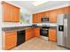 Well-equipped kitchen with wood cabinetry and stainless steel appliances at 2311 Chatham Place Dr, Orlando, FL 32824