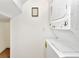 Convenient laundry area features a stacked washer and dryer and custom wall decoration at 2311 Chatham Place Dr, Orlando, FL 32824