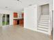 Open floor plan with a staircase leading to the second floor and kitchen with stainless steel appliances in the background at 2311 Chatham Place Dr, Orlando, FL 32824