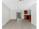 Open floor plan with sliding glass doors leading to the backyard and kitchen in the background at 2311 Chatham Place Dr, Orlando, FL 32824