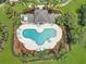 Overhead shot of the community pool with plenty of lounging chairs and tropical landscaping at 2311 Chatham Place Dr, Orlando, FL 32824