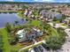 Aerial view of community pool featuring tropical landscaping, and ample parking at 2311 Chatham Place Dr, Orlando, FL 32824