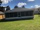 A large screened in patio area offers outdoor enjoyment, with a spacious grassy lawn and a partial fence at 2555 Palmetto Ridge Cir, Apopka, FL 32712