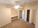 Bedroom features a built-in desk, carpet and ceiling fan at 2555 Palmetto Ridge Cir, Apopka, FL 32712