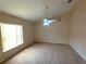 Bedroom featuring a bright window, ceiling fan and neutral carpet at 2555 Palmetto Ridge Cir, Apopka, FL 32712