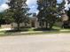 Charming single-story home with mature landscaping, beautiful trees and a well-manicured lawn at 2555 Palmetto Ridge Cir, Apopka, FL 32712