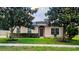 Charming single-story home with a well-manicured lawn and beautiful landscaping at 2555 Palmetto Ridge Cir, Apopka, FL 32712