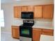 The kitchen features wooden cabinets, a black microwave and oven, and white countertops at 2555 Palmetto Ridge Cir, Apopka, FL 32712