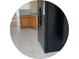 View of kitchen with stainless steel refrigerator and oak cabinets, and white tile flooring at 2555 Palmetto Ridge Cir, Apopka, FL 32712