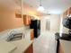 Kitchen featuring white tile flooring and stainless-steel sink at 2555 Palmetto Ridge Cir, Apopka, FL 32712