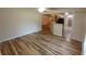 Open-concept living area featuring modern wood-look floors and neutral paint at 2555 Palmetto Ridge Cir, Apopka, FL 32712