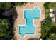 Aerial view of a community pool, lush landscaping, and lounge seating at 2598 Robert Trent Jones Dr # 1030, Orlando, FL 32835