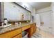 Bright bathroom featuring a granite countertop, framed mirror, and shower-tub combo at 2598 Robert Trent Jones Dr # 1030, Orlando, FL 32835