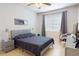 Cozy bedroom featuring a comfortable bed, neutral decor, and a window for natural light at 2598 Robert Trent Jones Dr # 1030, Orlando, FL 32835
