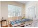 Bright dining area featuring a wooden table, white chairs, and a large window at 2598 Robert Trent Jones Dr # 1030, Orlando, FL 32835
