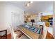 A dining area with wooden table, modern chairs, and seamless flow to living area and kitchen at 2598 Robert Trent Jones Dr # 1030, Orlando, FL 32835