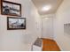 Inviting hallway with white walls, wood floors, and decorative art at 2598 Robert Trent Jones Dr # 1030, Orlando, FL 32835