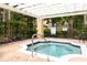 Community hot tub with pergola, surrounded by lush green landscaping at 2598 Robert Trent Jones Dr # 1030, Orlando, FL 32835