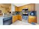 Charming kitchen featuring stainless steel appliances, granite counters, and wood cabinets at 2598 Robert Trent Jones Dr # 1030, Orlando, FL 32835