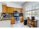 Bright kitchen with stainless steel appliances, wood cabinets, breakfast nook, and granite countertops at 2598 Robert Trent Jones Dr # 1030, Orlando, FL 32835