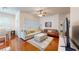 A cozy living room featuring hardwood floors, a ceiling fan, and comfortable sofas at 2598 Robert Trent Jones Dr # 1030, Orlando, FL 32835