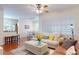 A cozy living room featuring hardwood floors, a ceiling fan, and an inviting couch at 2598 Robert Trent Jones Dr # 1030, Orlando, FL 32835
