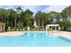 Large community pool surrounded by lounge chairs and lush landscaping at 2598 Robert Trent Jones Dr # 1030, Orlando, FL 32835