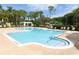 Large community pool surrounded by lounge chairs and lush landscaping at 2598 Robert Trent Jones Dr # 1030, Orlando, FL 32835