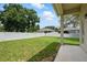 This backyard features a large lawn, a concrete patio, and a white vinyl fence at 2674 Spicebush Loop, Apopka, FL 32712