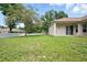 Spacious backyard with lush green lawn, white fence, and covered lanai providing a serene outdoor space at 2674 Spicebush Loop, Apopka, FL 32712